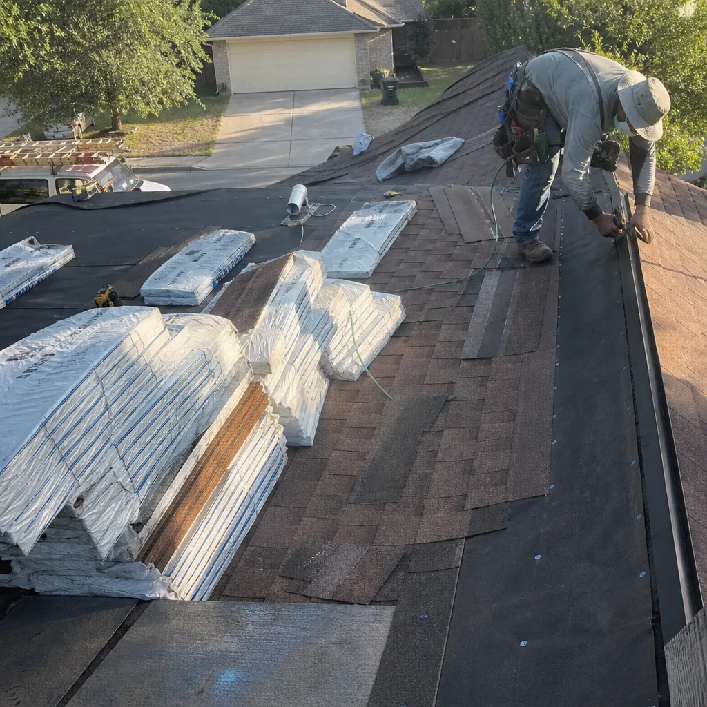 Professional roofer installing asphalt shingles on a residential roof replacement