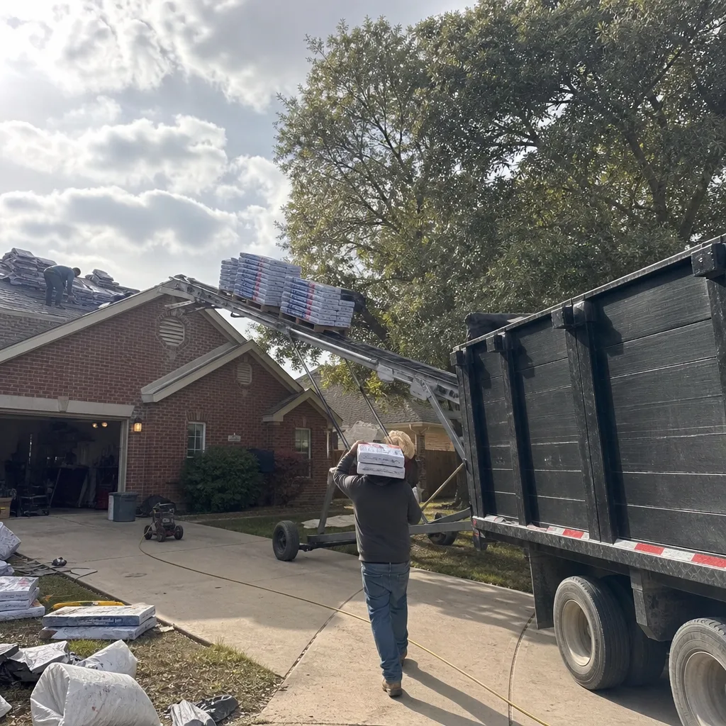 Roofing crew using a conveyor system to lift shingles to a roof